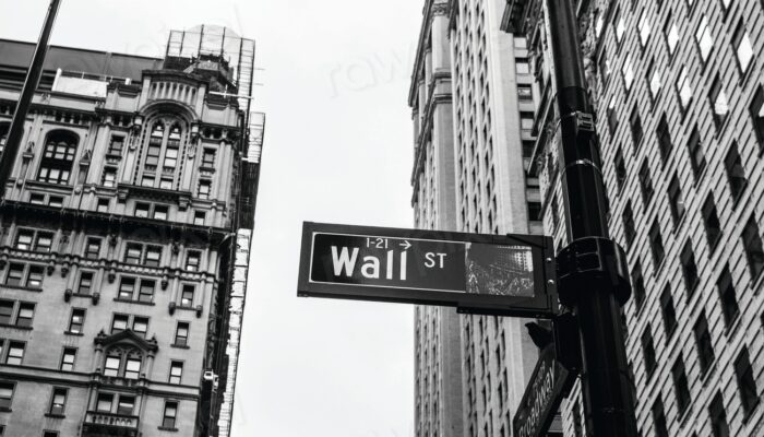 street sign pointing Wall Street